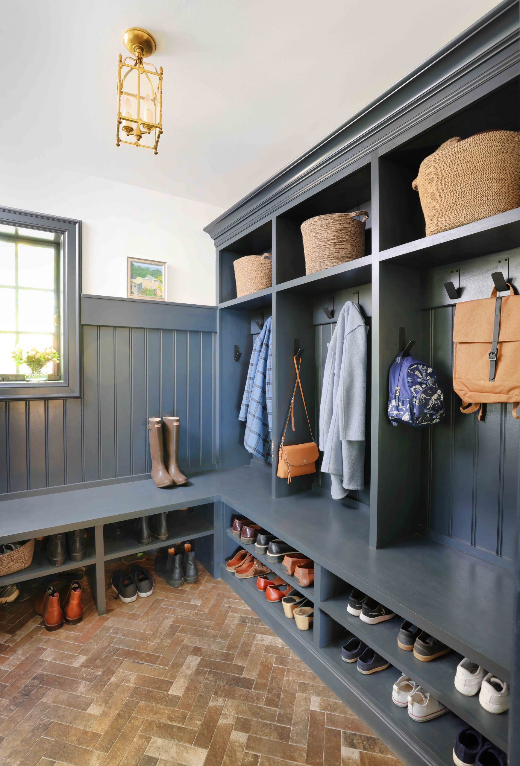 blue mudroom with herringbone flooring