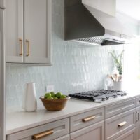 light gray kitchen with soft blue backsplash tile