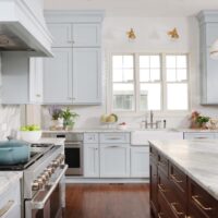 New Traditional style kitchen in a soft blue color with a stained walnut kitchen island