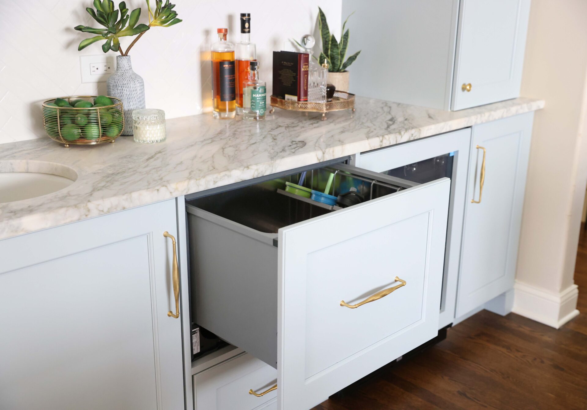 Dishwasher drawer in a soft blue wet bar as part of a traditional kitchen