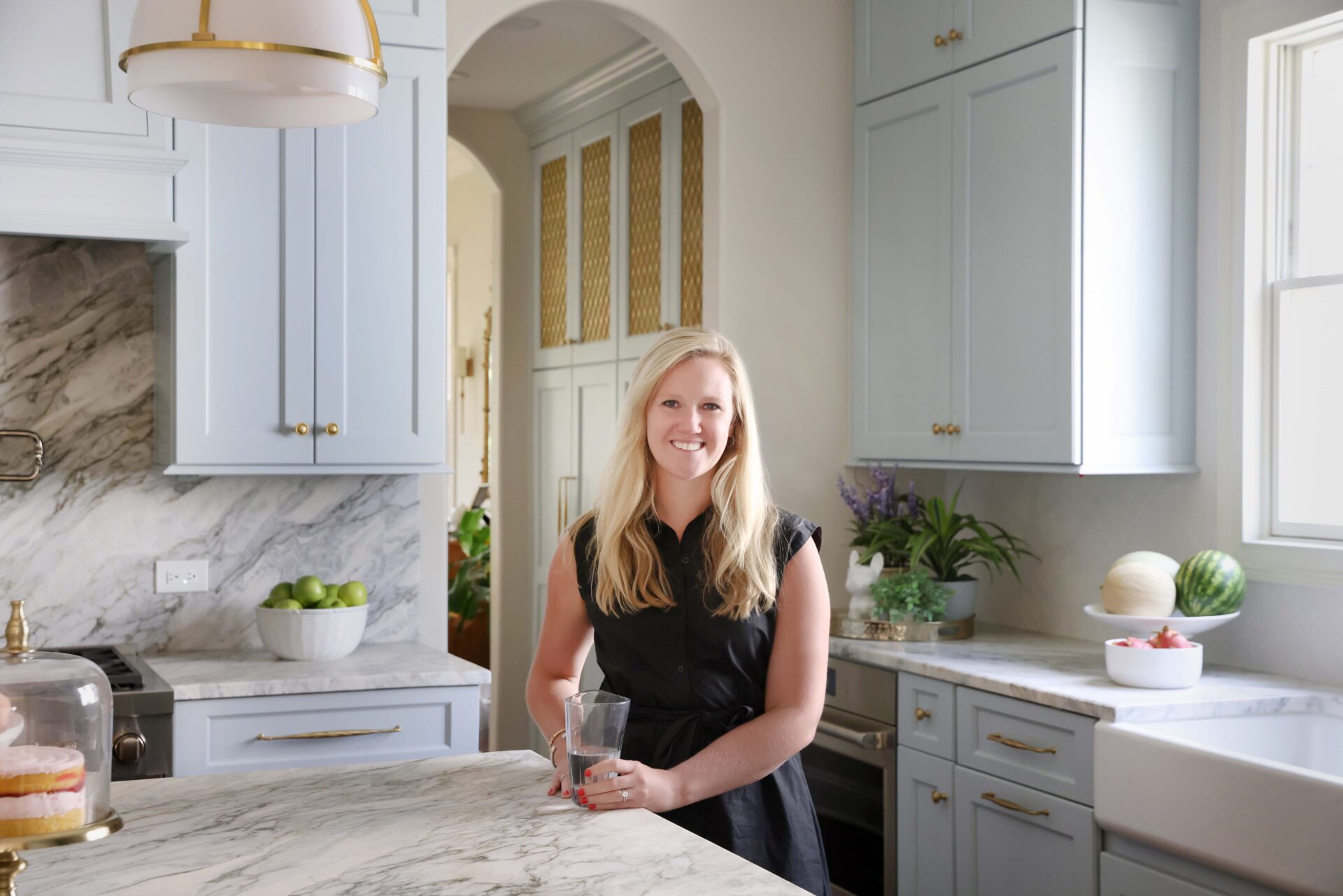 Homeowner in her light blue traditional kitchen